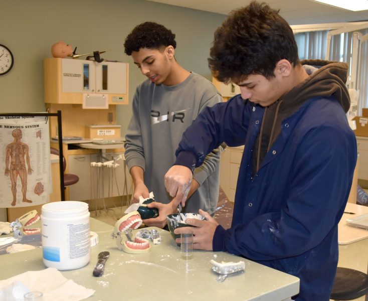 Students work on dental molds at the Michael Berry Career Center.