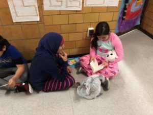 Pair of students reading in the hallway