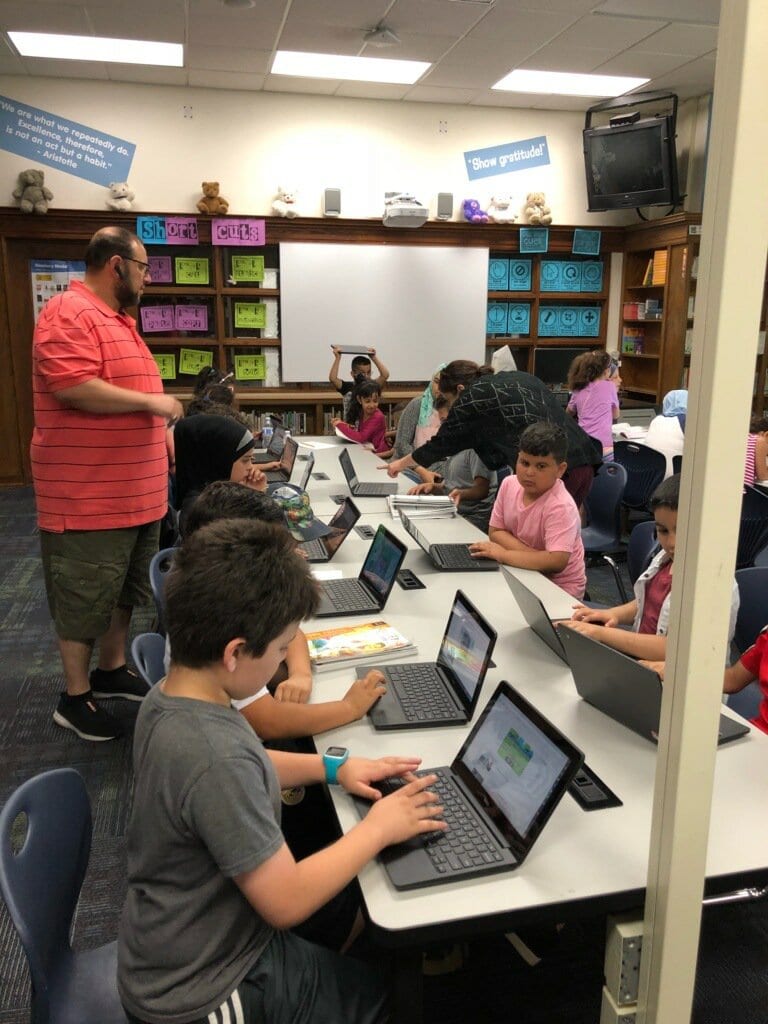 Students working in summer books and on chromebooks on our new program Exact Path