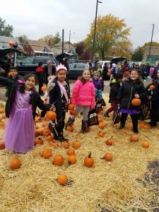 3rd graders posing with pumpkins