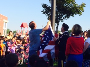 Mrs. Stanley, LT.Col. Gates and Mr. Mike raise the flag on the new school year.