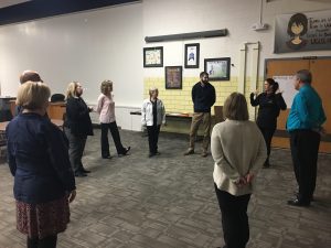 Administrators in a circle standing during playworks training