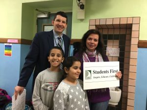Students, Ms. Elsaghir and the Superintendent with the Vision sign at the Stem night. 