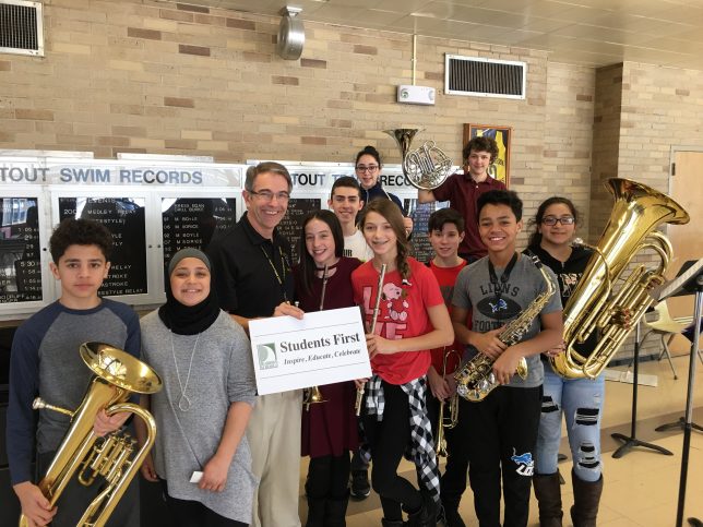 Mr. Walters and music students with instruments and the vision sign