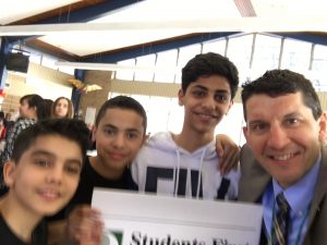 Superintendent and Students with the vision sign a selfie at Stout