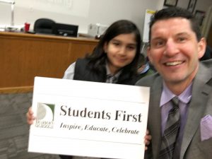 selfie with the sign at the board meeting