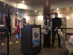 Students presenting at the Dearborn Rotary with a projector and podium