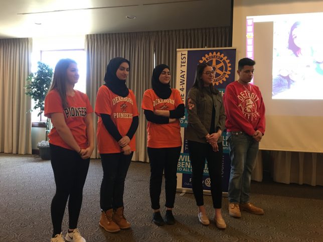 Students presenting at the Dearborn Rotary with a projector and podium