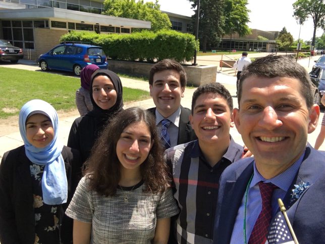 selfie with students in front of Dearborn High. 