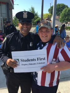 Students first sign and 2 adults at the parade. 