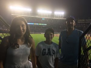 3 people at the Wrigley Field ball game