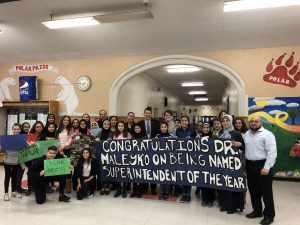 Superintendent Maleyko is surprised by Lowrey Staff staff, students and signs in the picture