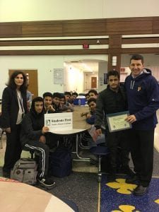 A presentation at Fordson with Students. Dr. Maleyko and Principal alcodary. Maleyko in the Fordson Shirt with the Vision sign. 