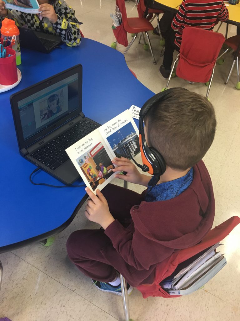 a boy recording himself reading