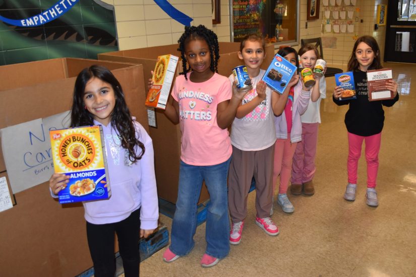 Howard students show some of the food donated for Battle Against Hunger.