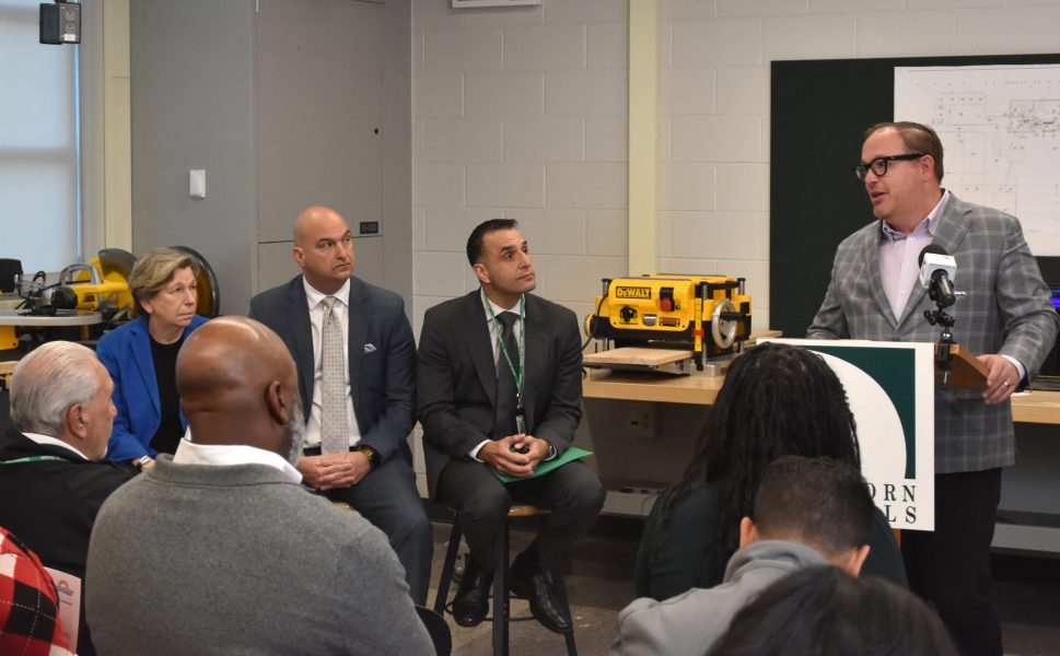 General Motors Vice President of Infrastructure and Corporate Citizenship David Massaron speaks while AFT President Randi Weingarten, Detroit Public Schools Community District Superintendent Nikolai Vitti, and Dearborn Public Schools Superintendent Mike Esseily look on.